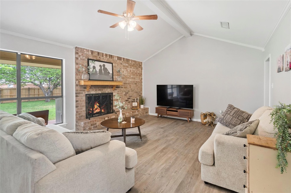 Living room with ceiling fan, vaulted ceiling with