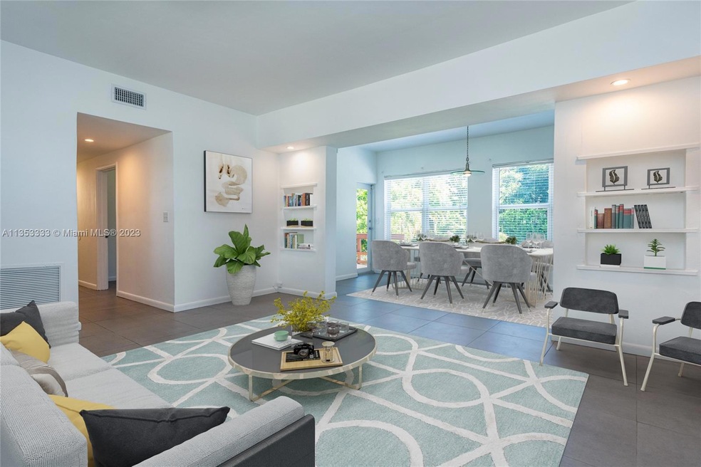 Virtually staged - Living room and dining room w/recessed shelves w/lighting + high 9' tall ceilings, all impact windows & doors. 