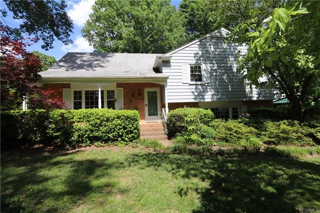 Covered front porch overlooks mature landscaping i