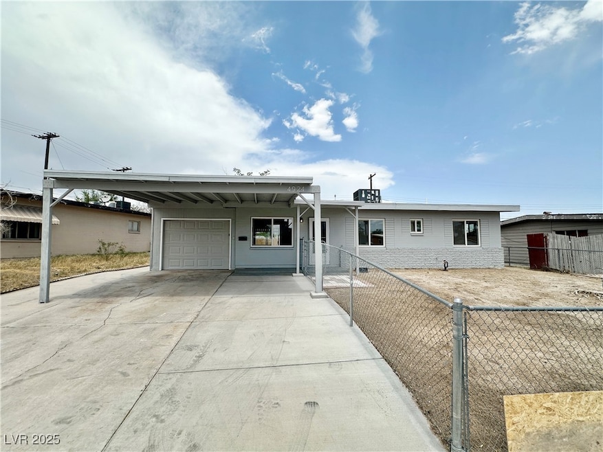 Ranch-style house with a carport, concrete drivewa