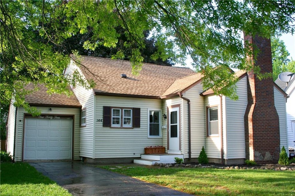 Front of house. Mature trees all around.