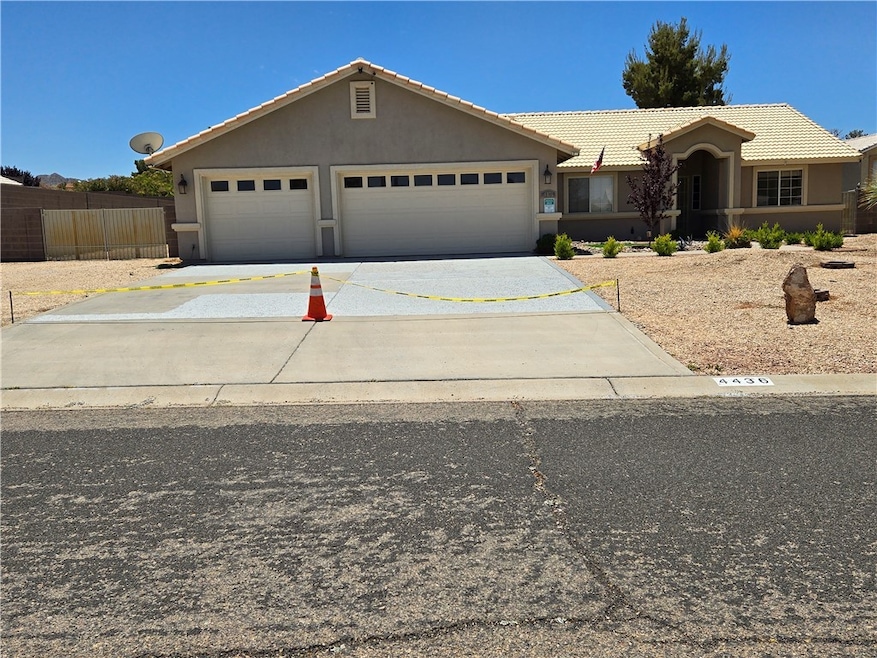 Ranch-style home with stucco siding, concrete driv