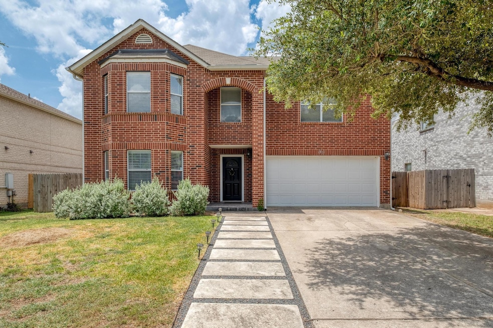 Traditional home featuring brick siding, an attac