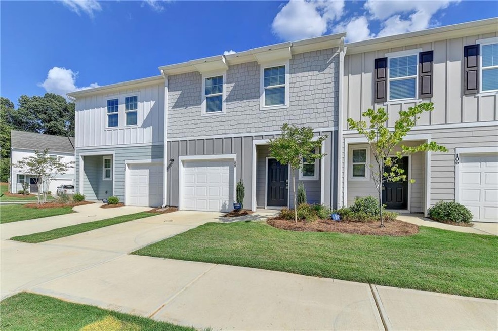 Townhome / multi-family property featuring a garag