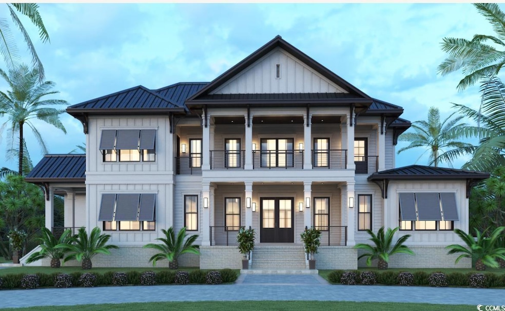 View of front facade with a balcony, metal roof, a standing seam roof, and french doors
