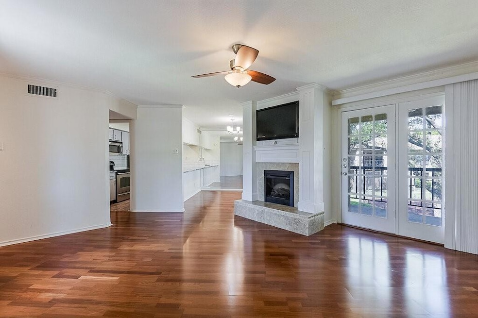 Unfurnished living room featuring wood finished fl