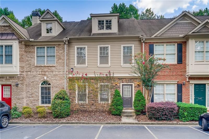 Classic townhome framed by beautiful crepe myrtles