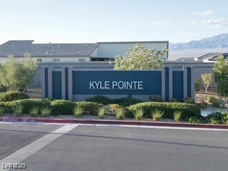 Community / neighborhood sign featuring a mountain