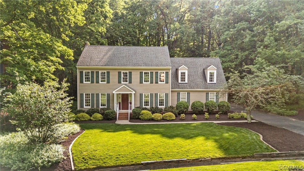 Colonial-style house with a front lawn