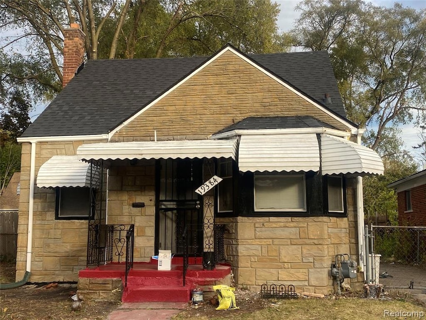 View of front facade with stone siding, a chimney, roof with shingles, and a porch