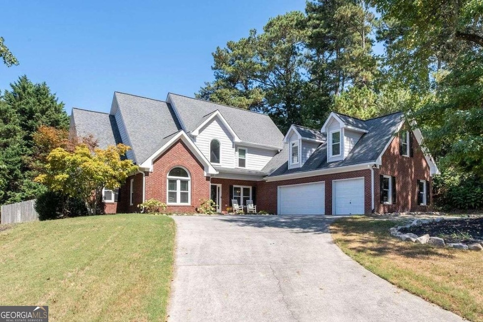 View from street up the driveway to 3-car SIDE-ENT