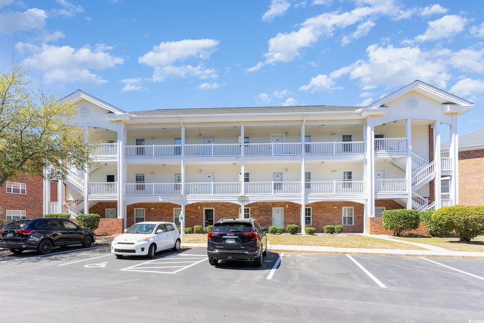 View of property with uncovered parking
