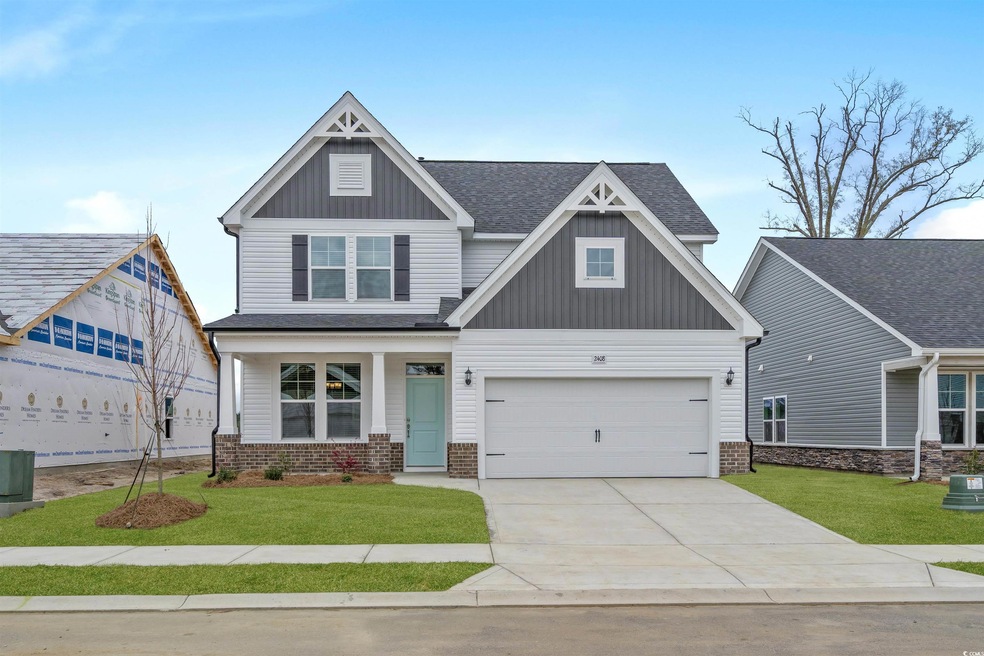 Craftsman-style house with a garage and a front ya