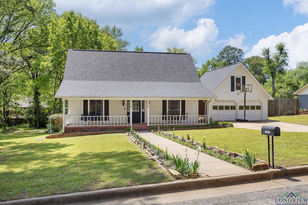 View of front facade with a porch, concrete driveway, and roof with shingles