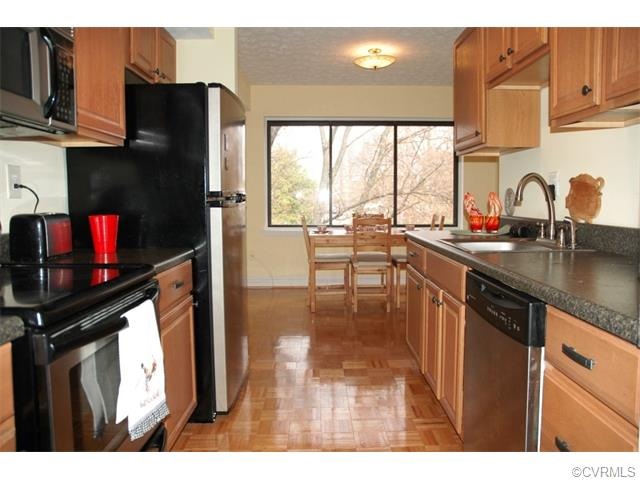 Remodeled kitchen with new countertops, wood parqu