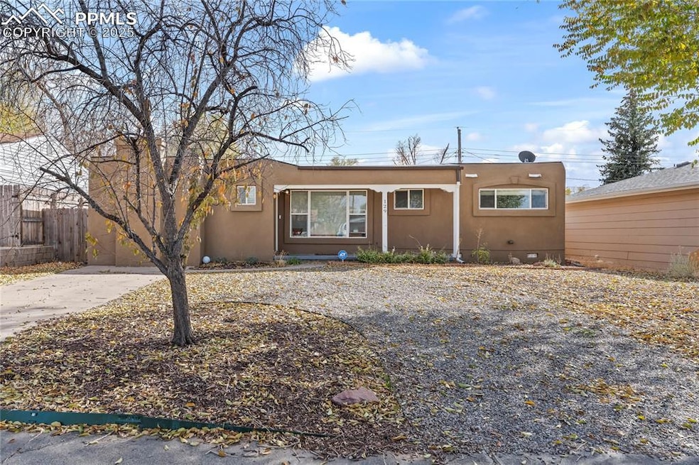 View of front of house featuring stucco siding and driveway