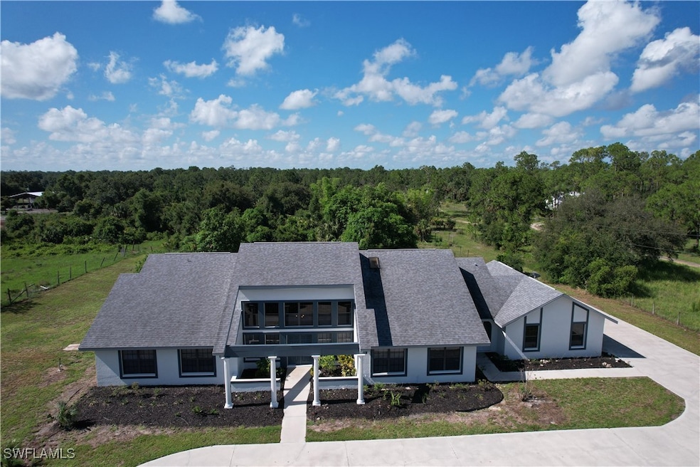 View of front of house with a forest view, a shing