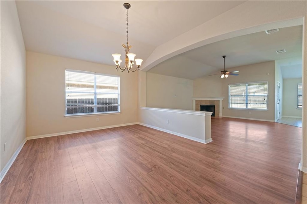 Empty room with ceiling fan, lofted ceiling, a ch