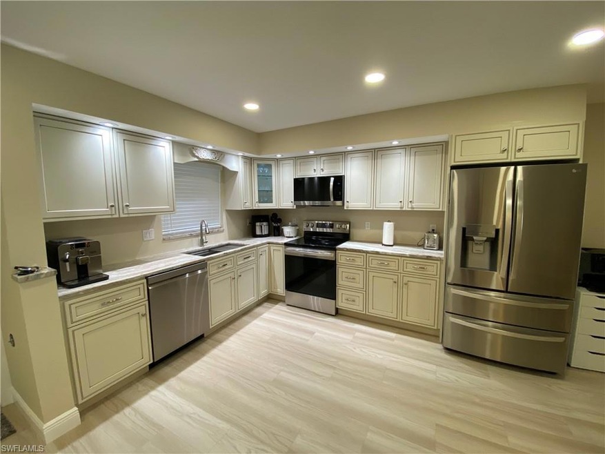 Kitchen with stainless steel appliances, a sink, l
