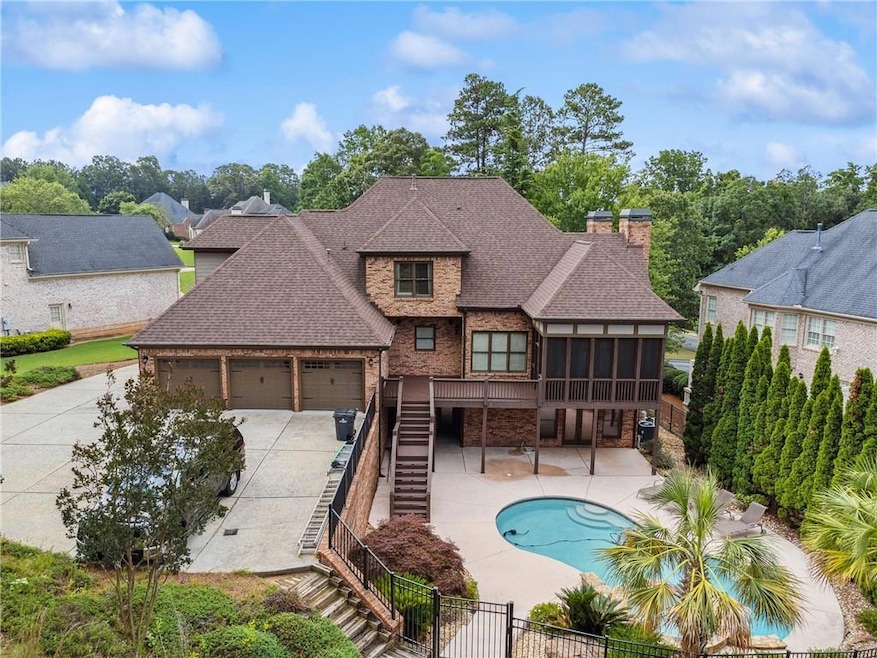 Rear view of property with stairway, a sunroom, a shingled roof, a fenced backyard, and a chimney