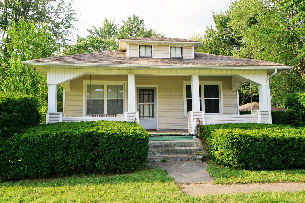 Beautiful front covered porch with porch swing.