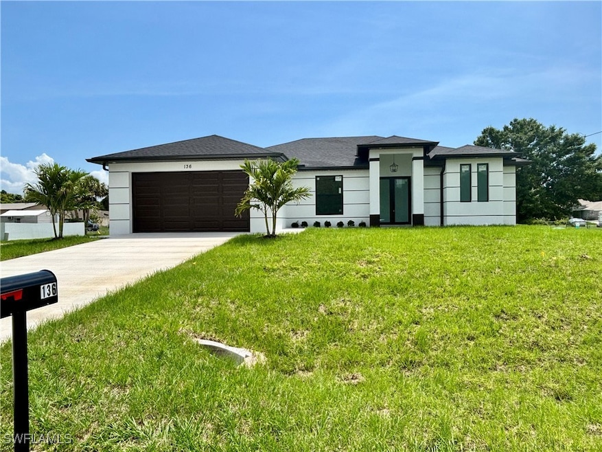 Prairie-style home featuring driveway, an attached
