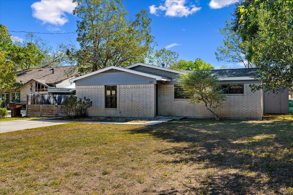 View of front of home with brick siding and a fro