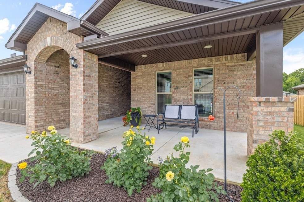 Covered front porch and entry.
lovely flower beds