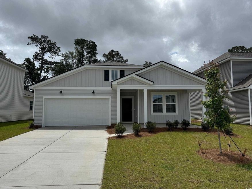 View of front of house with driveway, a front lawn