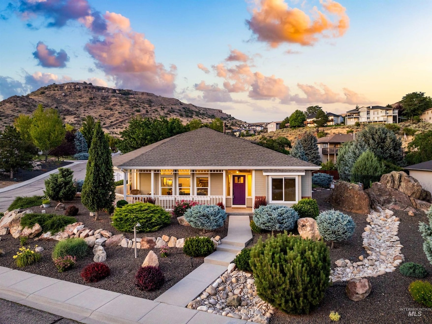 View of front of house with a porch, a mountain view, and a shingled roof