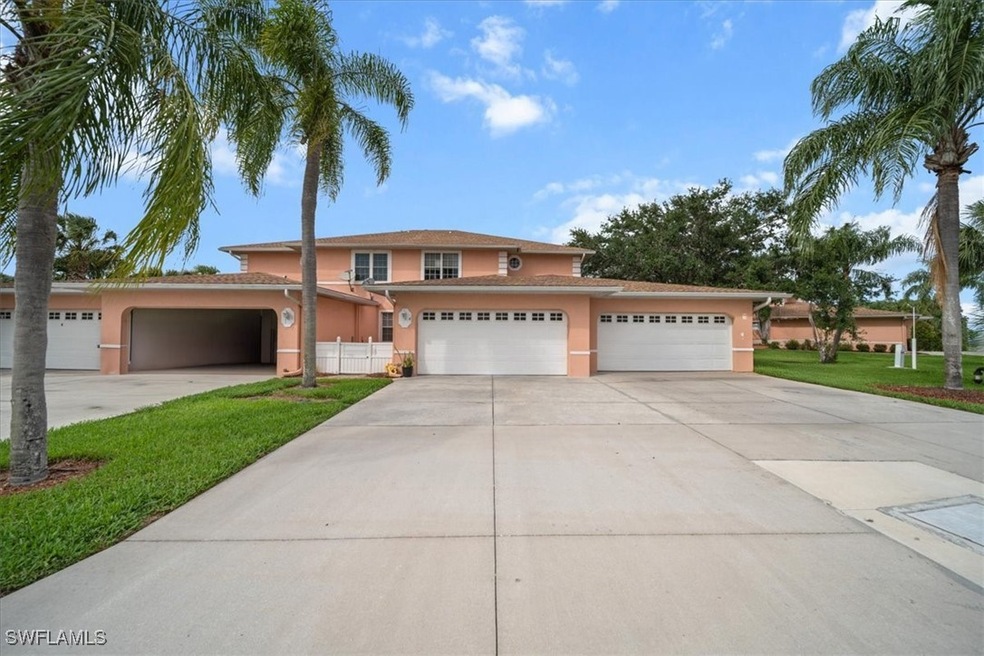 Traditional-style home with stucco siding, drivewa