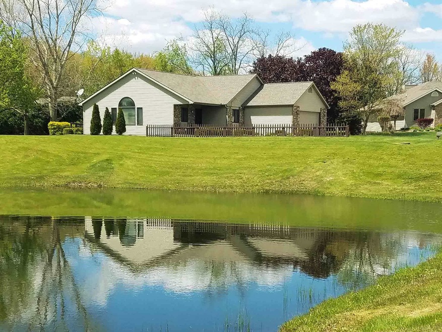 Home and yard from across pond.