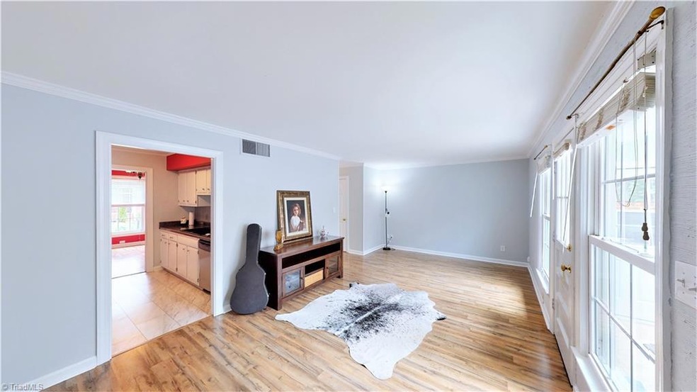 Fresh Paint & New Floors in with access to the sunroom and so much natural light!