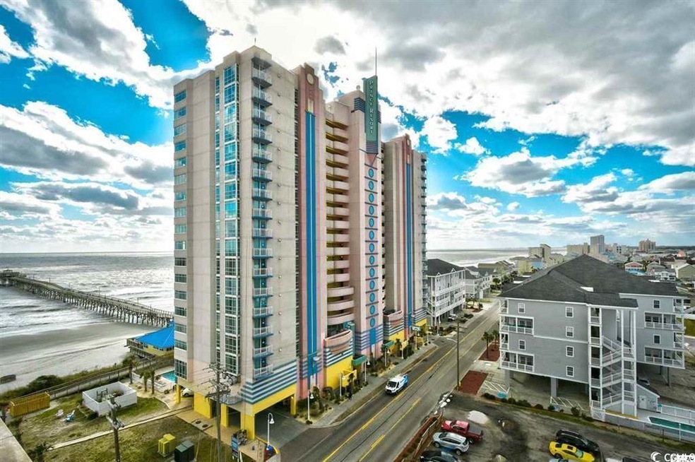 View of building exterior with a water view and a city view