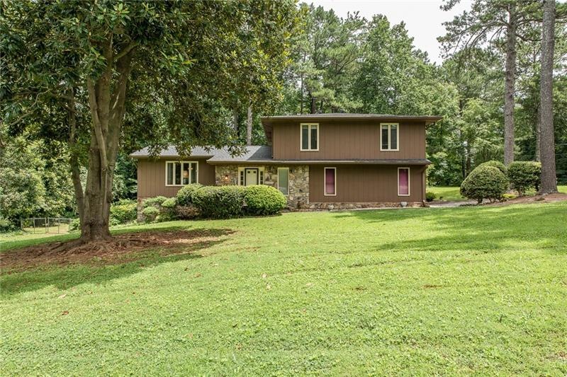 Pristine setting with mature trees and landscaping