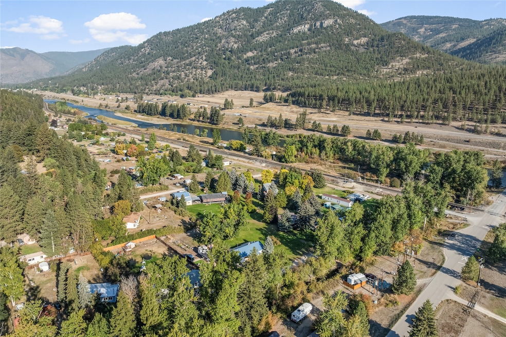Aerial view of property's location with a water and mountain view