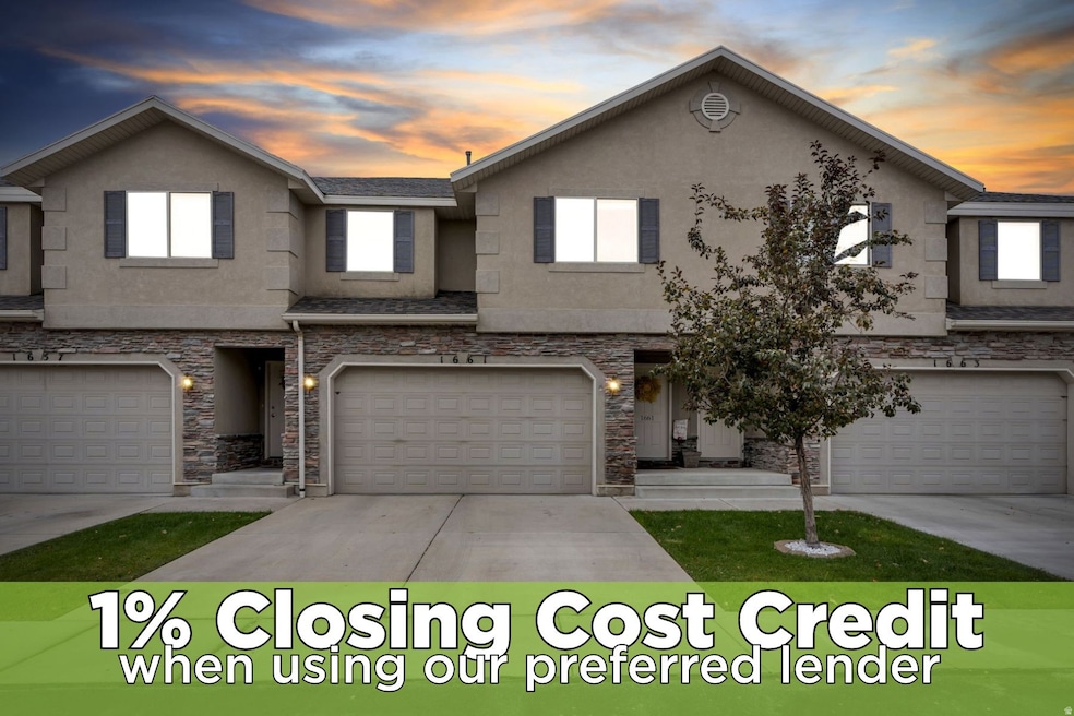 View of front facade with stucco siding, stone siding, concrete driveway, and an attached garage