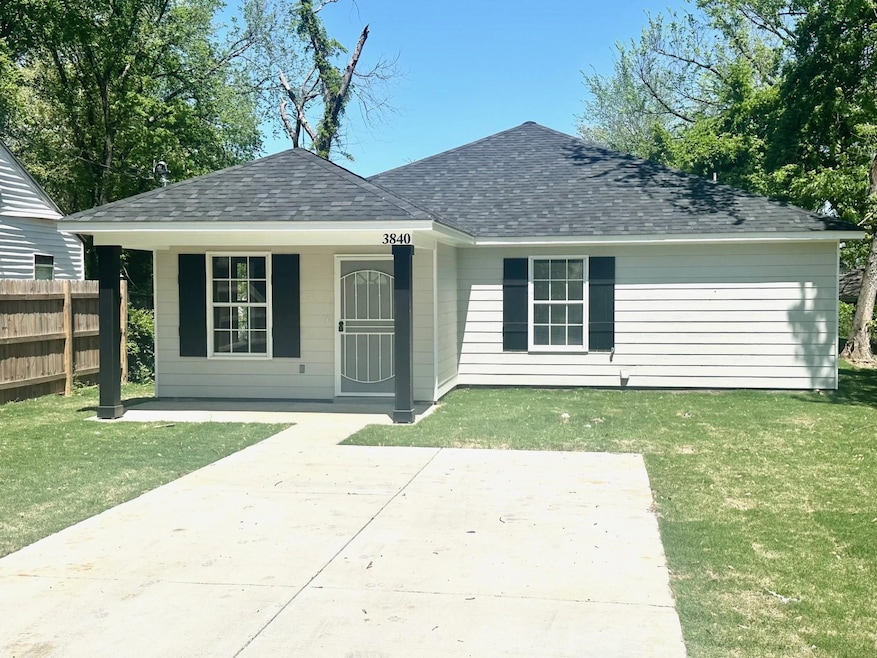Rear view of property featuring a shingled roof and a porch