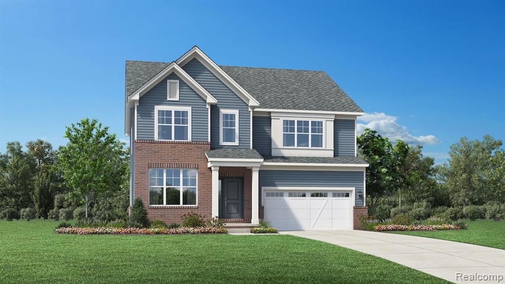 View of front of property with a front yard, a shingled roof, a garage, driveway, and brick siding