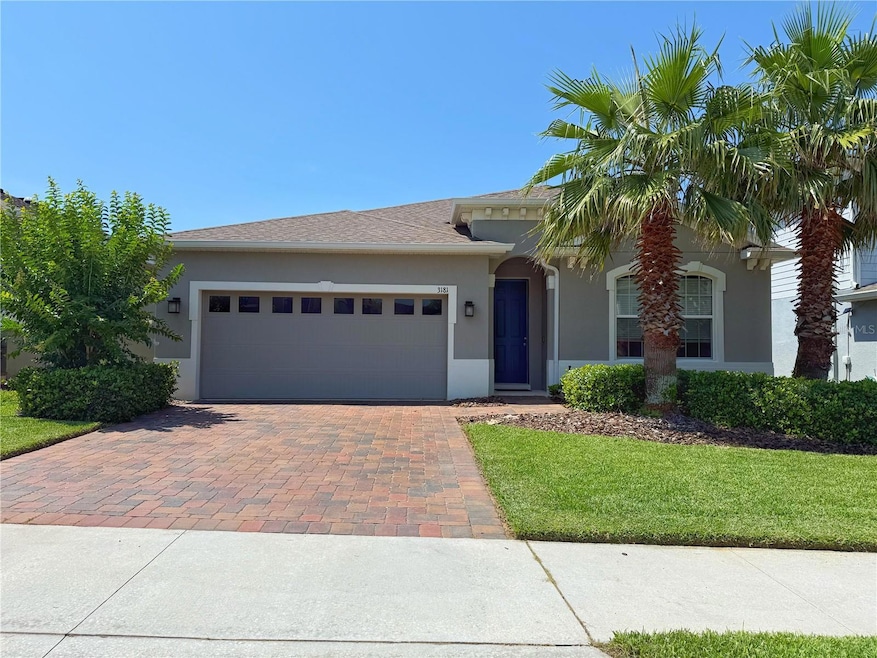 Front exterior with gutters, paver driveway, ring system and fenced in yard