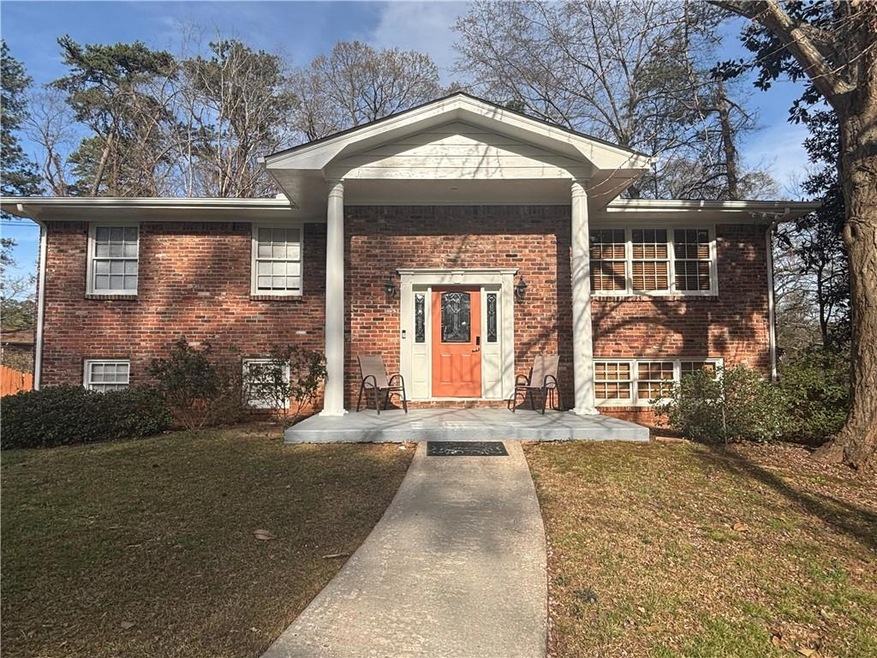 View of front of home featuring brick siding, cove