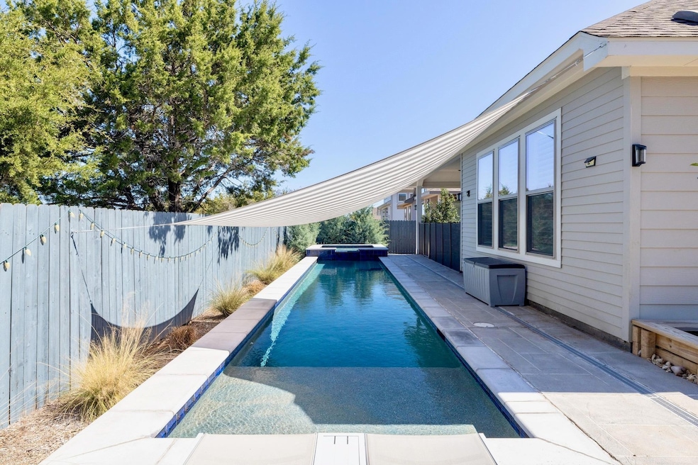 View of swimming pool featuring a patio area, a f