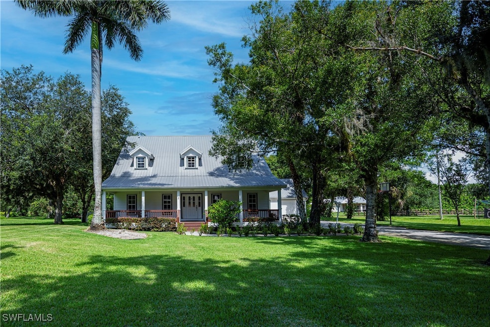 Cape cod home with a porch, a front yard, and a me