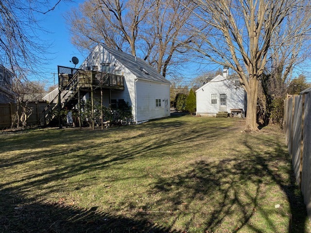 Backyard view of main house and detached garage with apartment