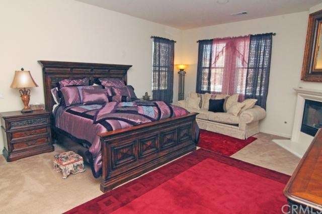 Spacious Master bedroom suite with fireplace, included is access and view to backyard. 