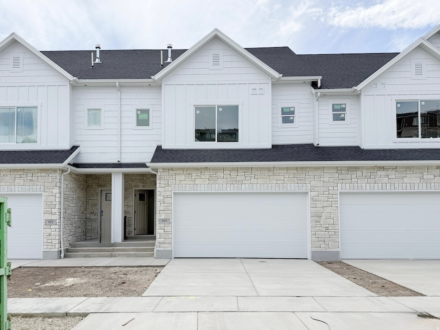 View of front of property with board and batten siding, stone siding, concrete driveway, a shingled roof, and a porch
