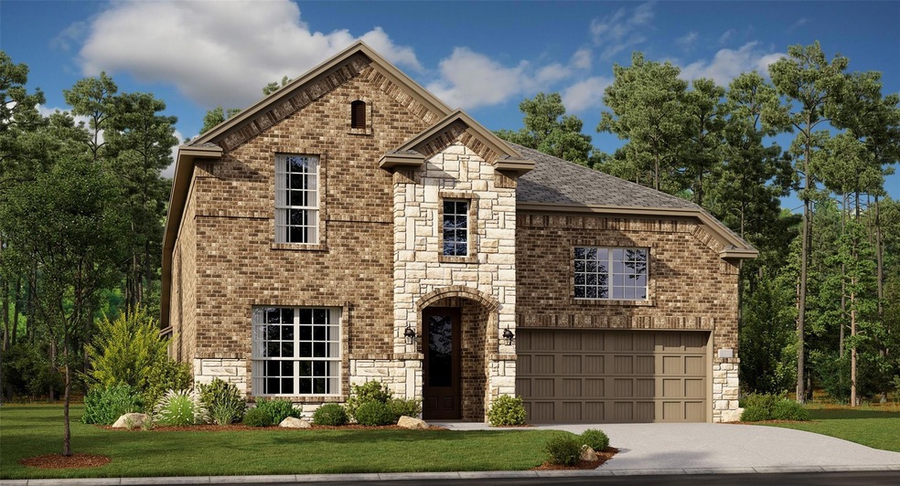 View of front of home with a front lawn and a gara