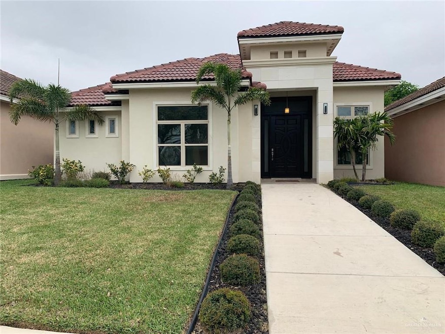 Mediterranean / spanish-style house featuring a front lawn, stucco siding, and a tiled roof