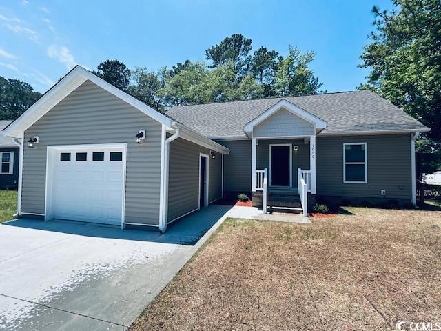 Single story home featuring driveway, an attached garage, and a shingled roof