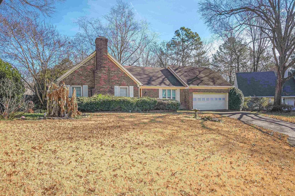Ranch-style home with a garage and a front lawn